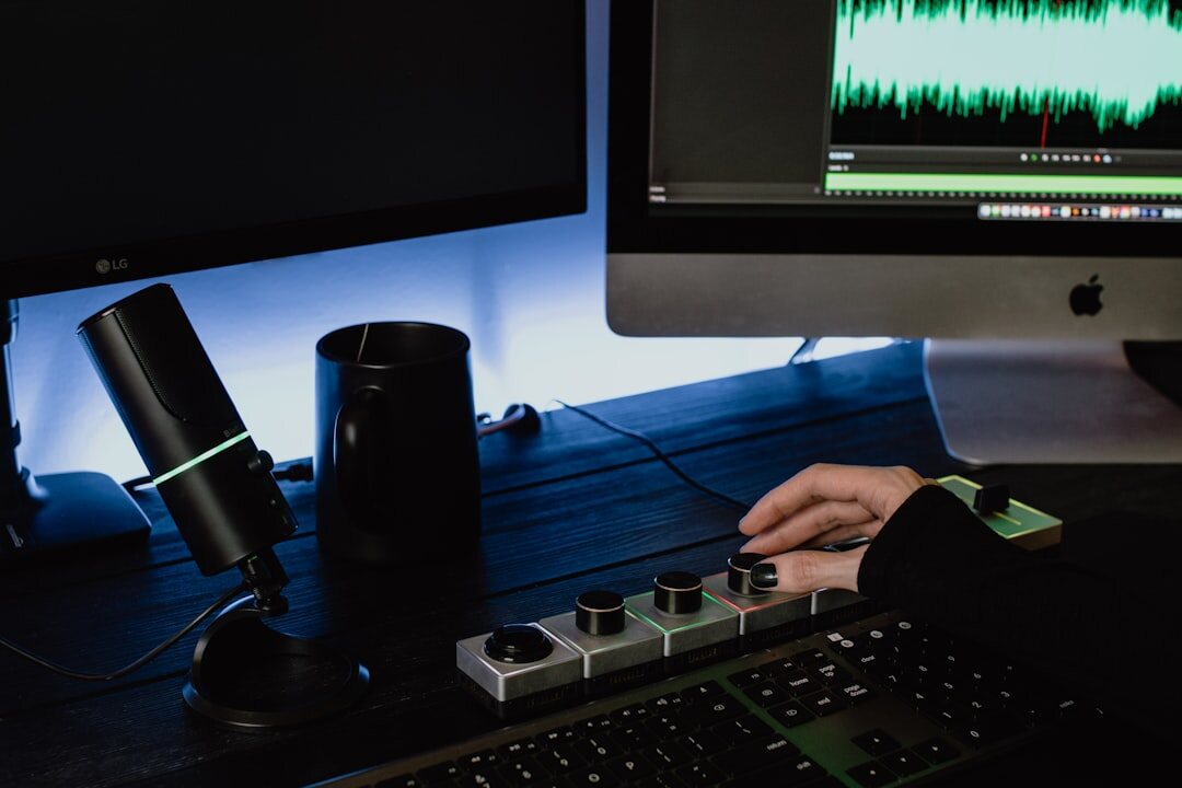 person editing audio on computer