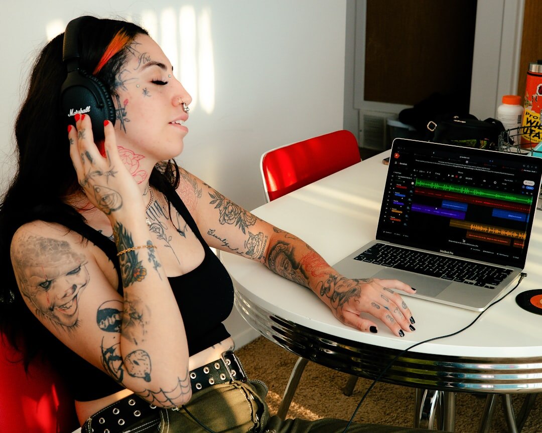 person editing audio on laptop