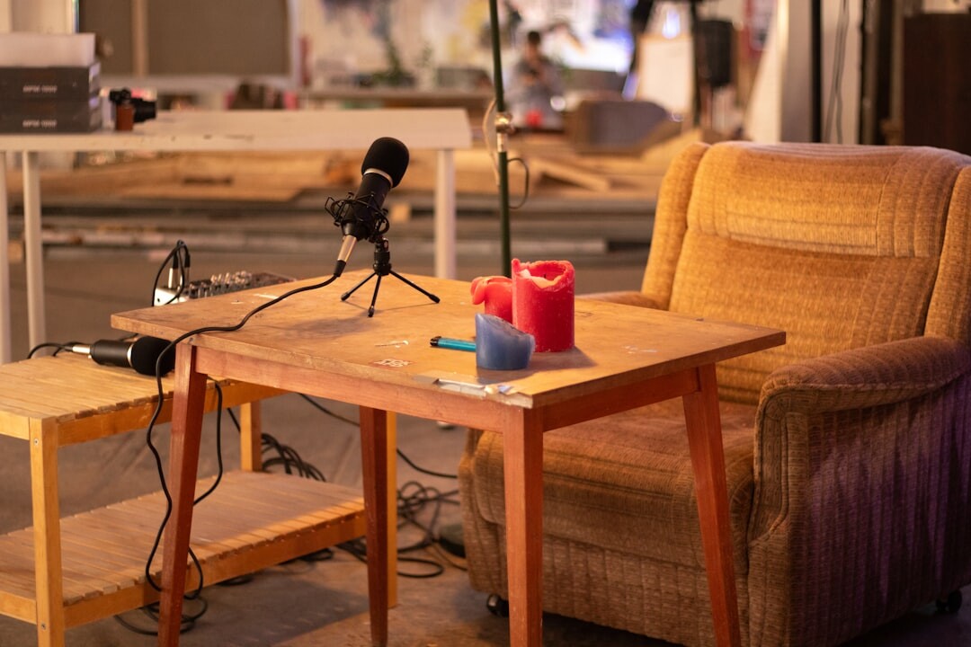 Overhead view of a podcast recording table with microphones and notebooks